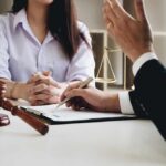 Teacher Pleads Guilty In Child Sex Case Two people in a legal consultation at a desk