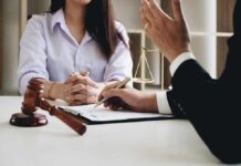 Two people in a legal consultation at a desk