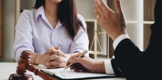 Two people in a legal consultation at a desk