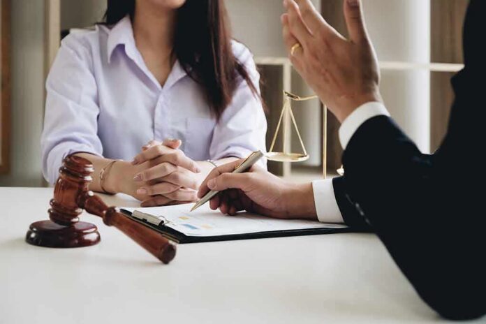 shutterstock_1067138630 Two people in a legal consultation at a desk