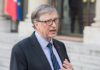 Gates Warns: AI Could Kill Billions Bill Gates speaking outdoors in a suit and tie