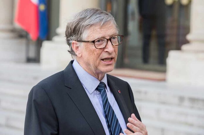 shutterstock_1070620823 Bill Gates speaking outdoors in a suit and tie