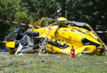 What Investigators Found Before Helicopter Crash yellow helicopter crash scene on grassy field