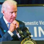 What Biden Actually Withheld From Israel man at podium speaking with hands clasped near chin