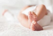 Massachusetts Baby Plan Triggers Trust War baby feet on a soft white blanket