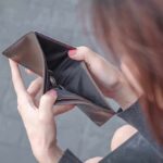 Hands holding an open empty wallet