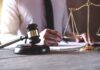 Judge's gavel and scales of justice on desk