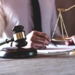 FEMA Stall Leaves LA In Recovery Limbo Judge's gavel and scales of justice on desk