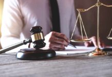 Judge's gavel and scales of justice on desk