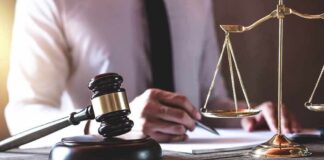 Judge's gavel and scales of justice on desk