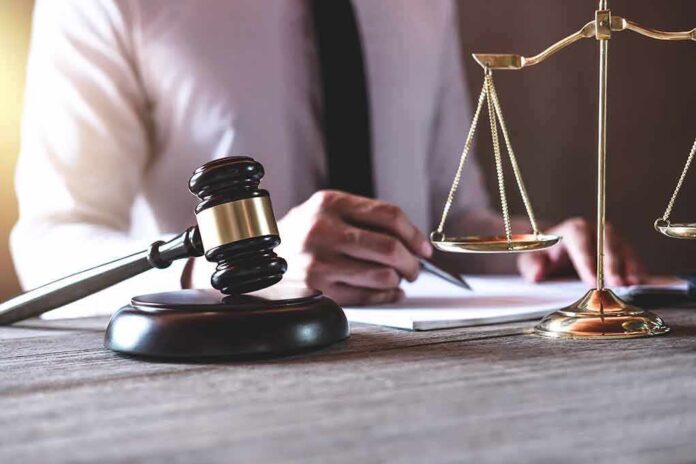 shutterstock_1177368778 Judge's gavel and scales of justice on desk