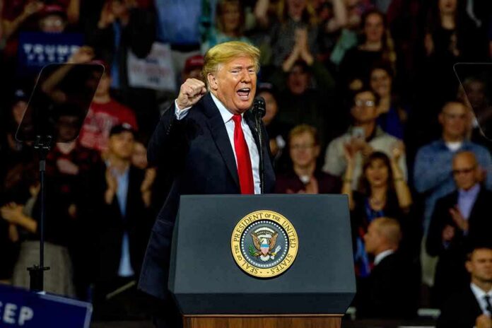 man speaking at a podium during a rally