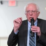 Unity Talk, Money Mystery in Michigan Elderly man speaking into a microphone