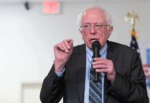Elderly man speaking into a microphone