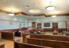 Judge Greenlights Shocking Kirk Murder Trial Empty courtroom with wooden benches and judge's bench