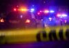 Rest-Stop Bloodbath Stuns I-80 Police cars with flashing lights behind yellow caution tape at night