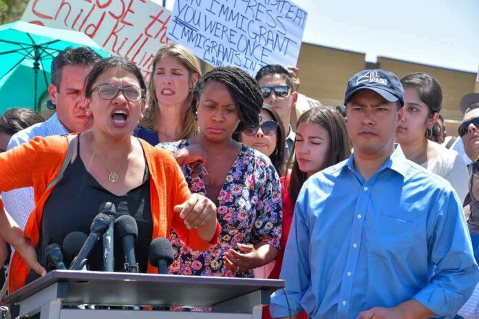 Rashida Tlaib speaks at a podium with Ayanna Pressley and Joaquín Castro beside her; Pete Aguilar behind
