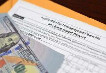 Unemployment benefits application with cash and envelope