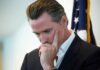 Newsom Claims Slammed By His Own Numbers man in suit touching his face thoughtfully