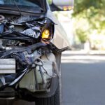 License Loophole Tied To Deadly Crash Front of a car with severe collision damage and exposed headlight
