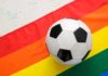Judge Deals DOJ Challenge A Major Setback Soccer ball on a rainbow flag