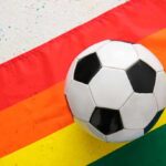 Judge Deals DOJ Challenge A Major Setback Soccer ball on a rainbow flag