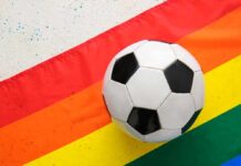 Judge Deals DOJ Challenge A Major Setback Soccer ball on a rainbow flag