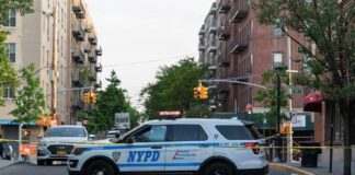 NYPD police SUV blocking a city street at a taped-off scene