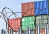 EU’s Wild Canada Play Sparks Tariff Talk Barbed wire fence in front of stacked shipping containers