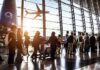 Five Years Later, Abbey Gate Questions Remain Passengers queue inside an airport terminal at sunset