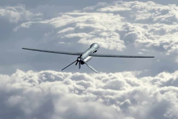 shutterstock_2275288473 Unmanned aerial drone flying above clouds