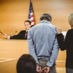 Judge Lets Accused Attacker Walk Defendant in handcuffs stands before a judge in a courtroom