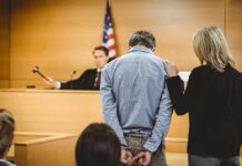 Judge Lets Accused Attacker Walk Defendant in handcuffs stands before a judge in a courtroom