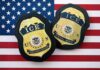 ICE Vetting Chaos Exposed ICE badges on an American flag background