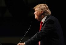 Trump Torches Globalism at the UN Donald Trump speaking at a podium in profile against a dark background