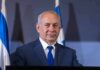 Empty Seats Humiliate Netanyahu man in suit at podium with microphones