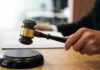 Custody Clash Turns Deadly Judge's hand holding a gavel over a sound block