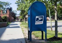 FBI Probes Election Mail Threats Blue USPS mailbox on a suburban sidewalk
