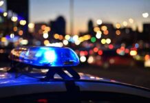 Eve-Of-Race Horror Shakes Detroit Running Police car light bar flashing at dusk