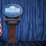Early Mic Drop: Trump’s Messenger Arrives White House press briefing podium with U.S. flag and blue curtain