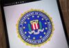Media Fumble Exposed by FBI FBI seal displayed on a smartphone screen