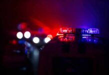 Crowd Panic Outside FAMU Stadium Police car light bar flashing red and blue at night