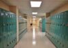 Whistleblower Claims Rigged Credits School hallway with rows of teal lockers