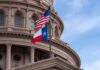 Record Cash War Erupts In Texas Texas and U.S. flags in front of a capitol building dome