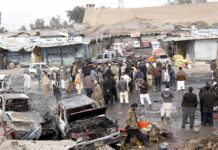Rescuers Pull Kids From Rubble Crowd gathers at a market after a vehicle explosion