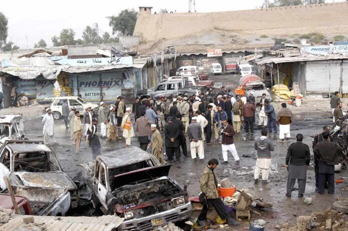 shutterstock_122090671 Crowd gathers at a market after a vehicle explosion
