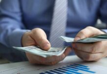 Trump’s $90 Medicare Payment Hits Seniors Hands counting cash over financial documents