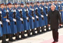 Vladimir Putin walks past an honor guard; Genaro García Luna and Darius Kilgo not visible