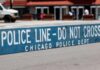 Police barricade with 'Do Not Cross' message in urban street