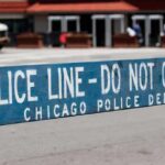 Police barricade with 'Do Not Cross' message in urban street